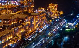 Chongqing, China - July 23, 2019: Hongya cave in Chongqing with modern skyline and skyscrapers in the background
