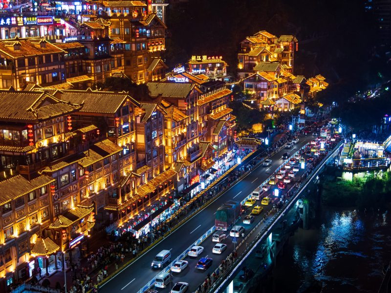Chongqing, China - July 23, 2019: Hongya cave in Chongqing with modern skyline and skyscrapers in the background